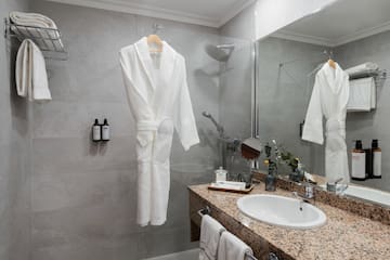 a bathroom with a white robe and sink