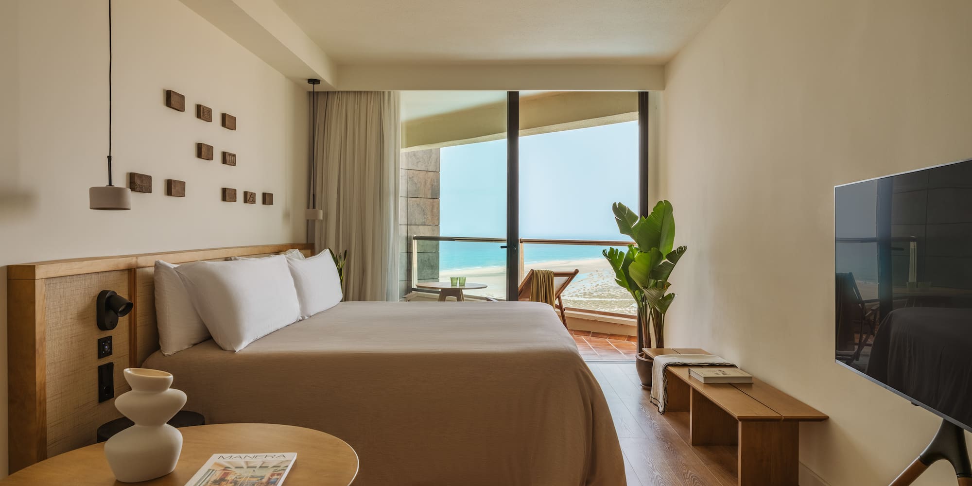 a bedroom with a large bed and a television