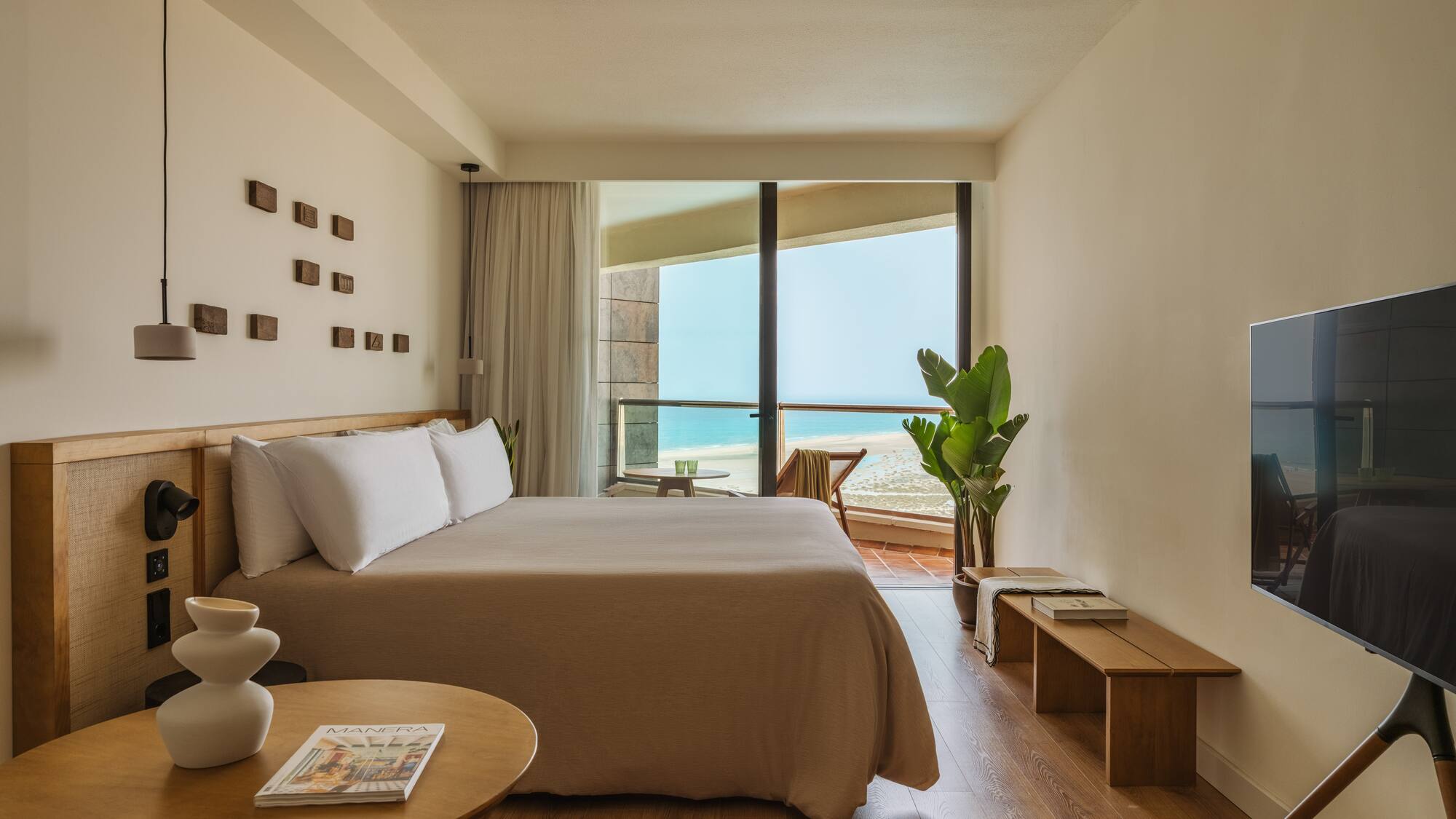 a bedroom with a large bed and a television