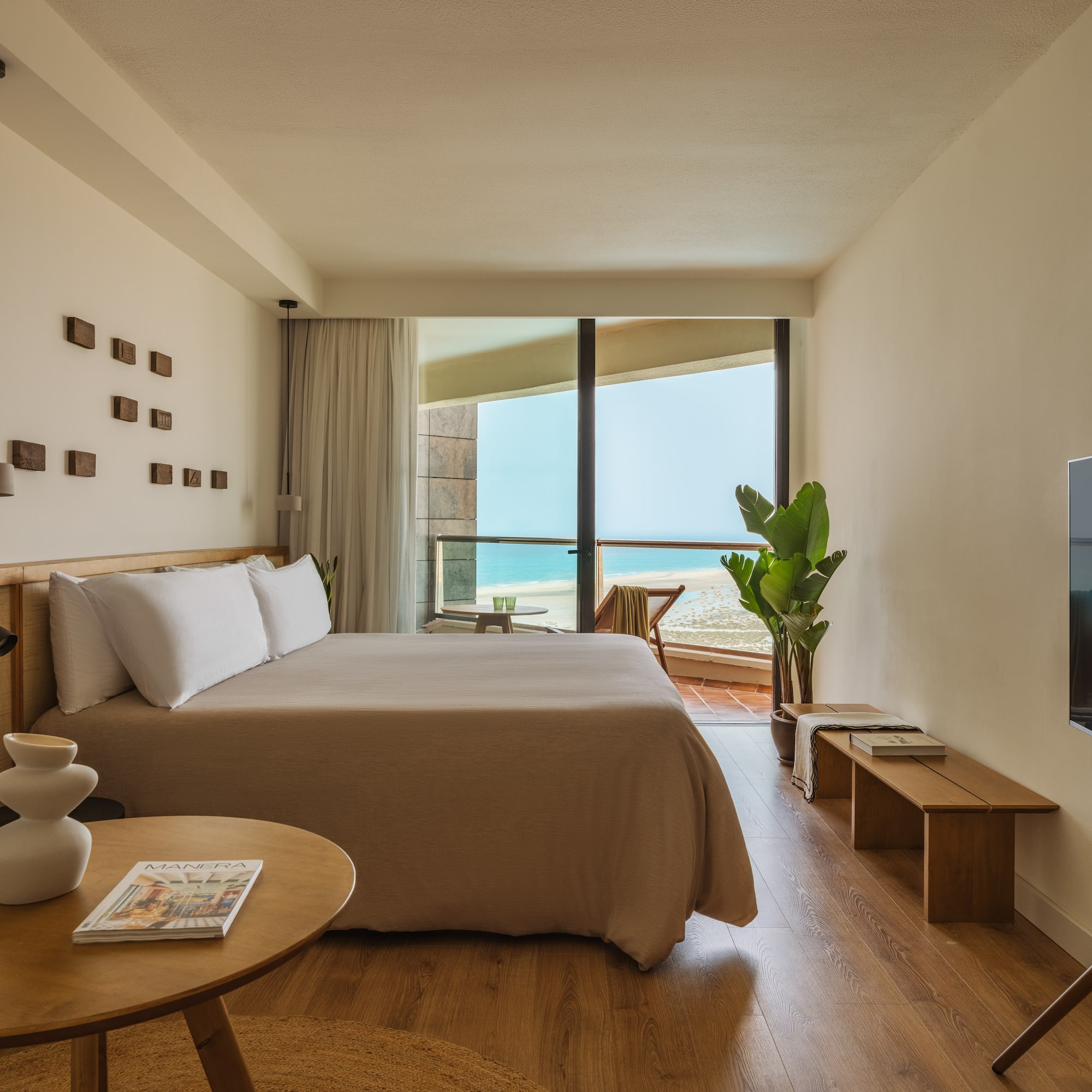 a bedroom with a large bed and a television