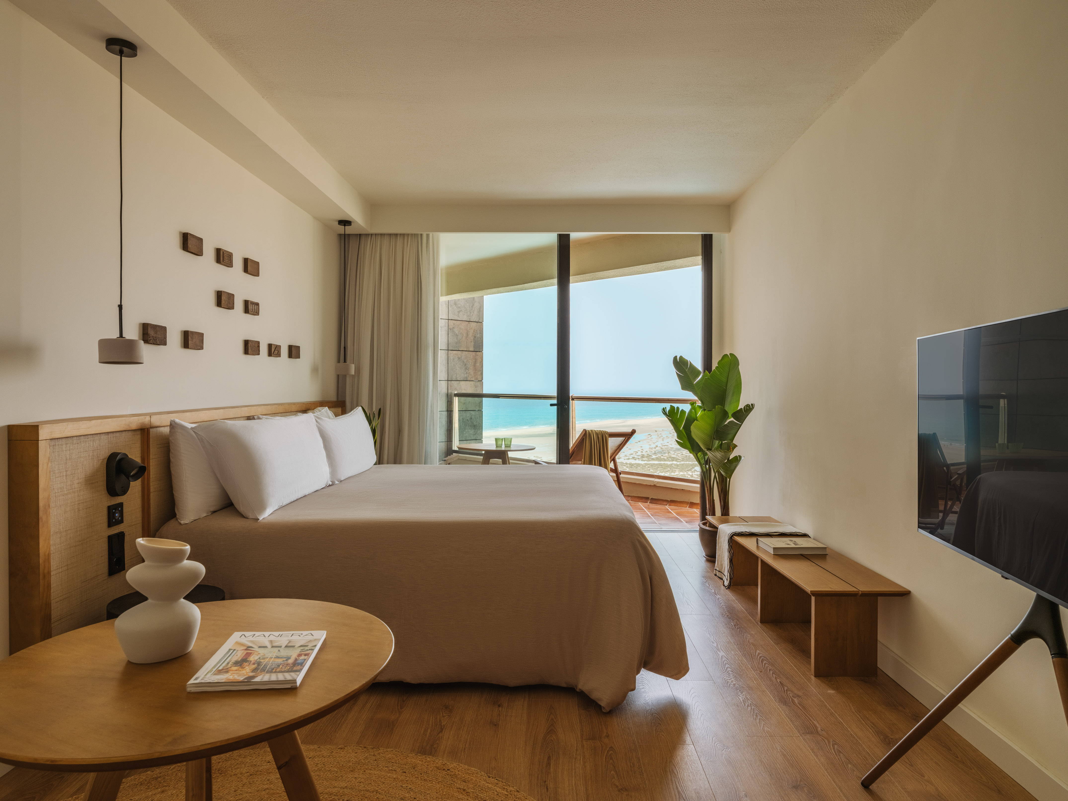 a bedroom with a large bed and a television