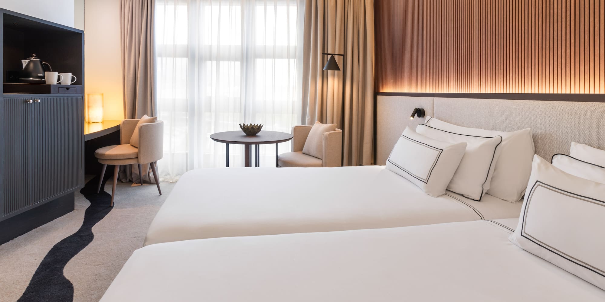 a room with two beds and a table