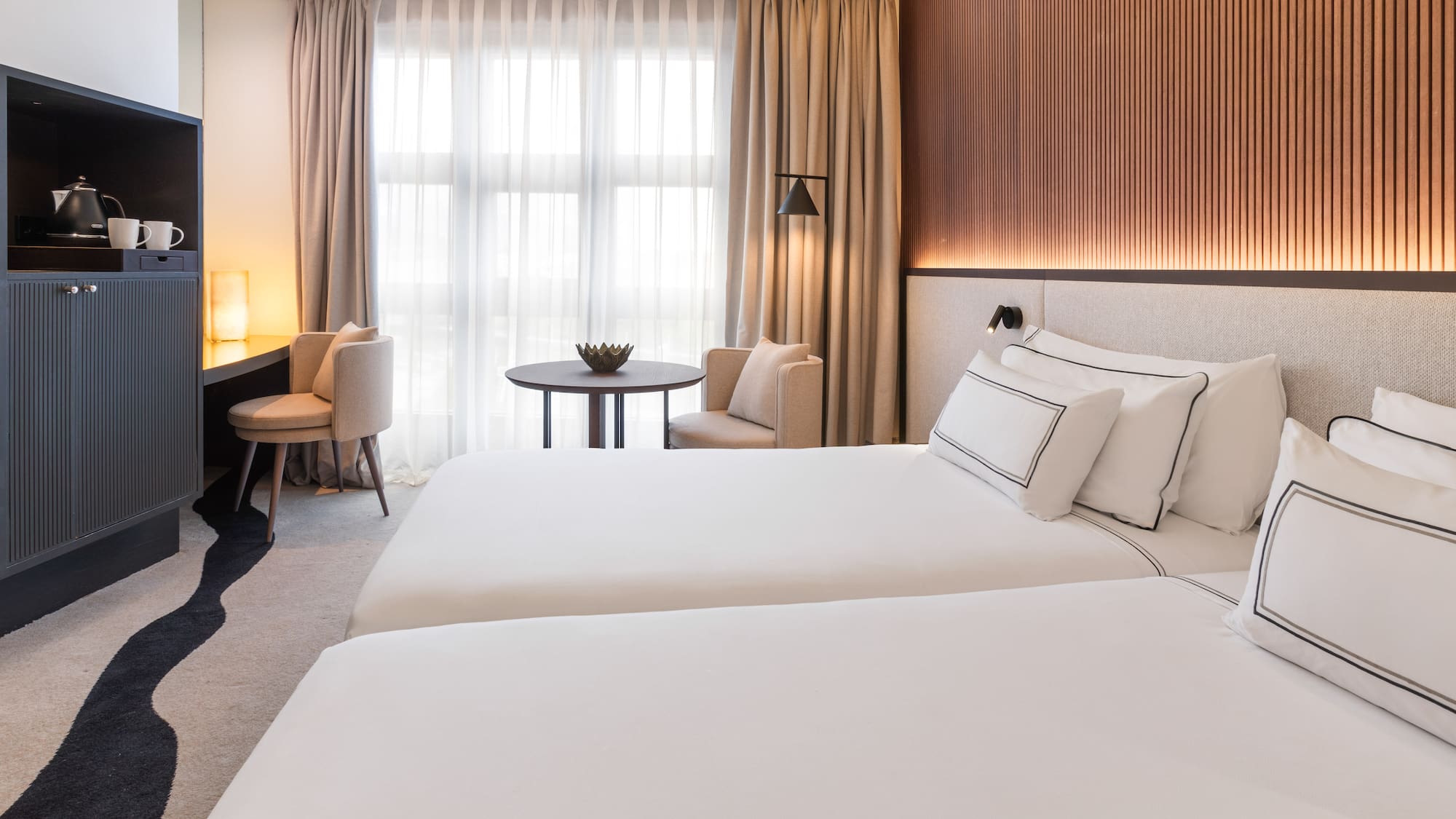 a room with two beds and a table