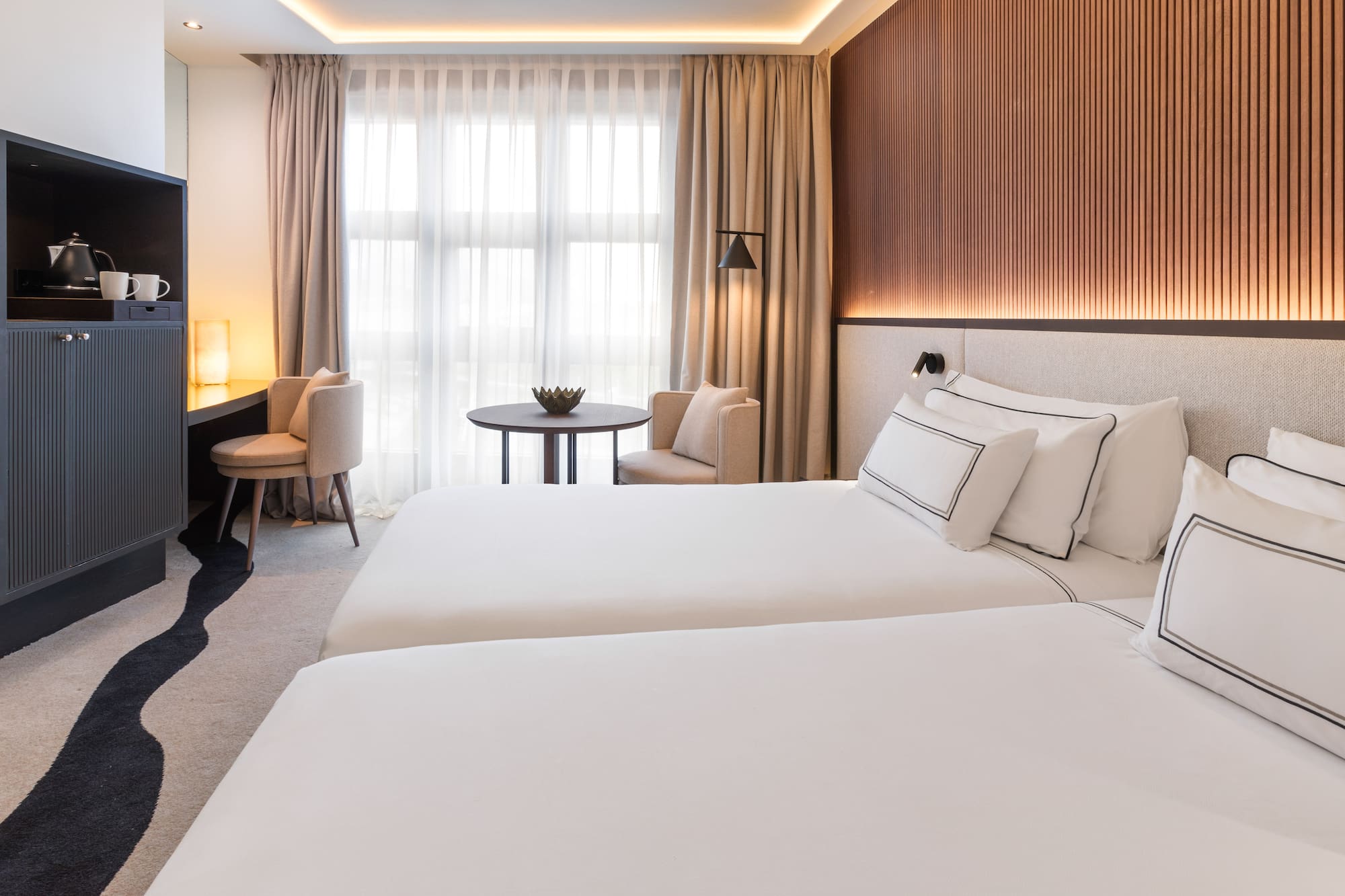 a room with two beds and a table