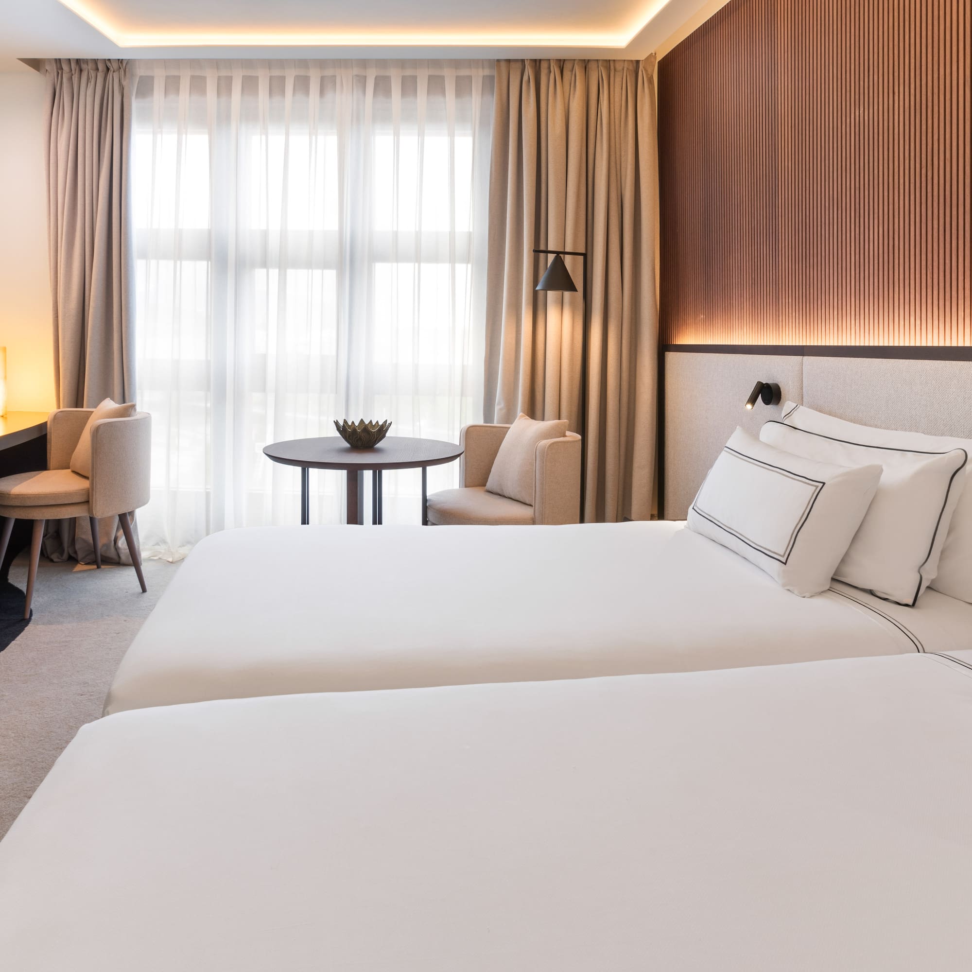 a room with two beds and a table