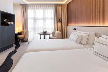 a room with two beds and a table