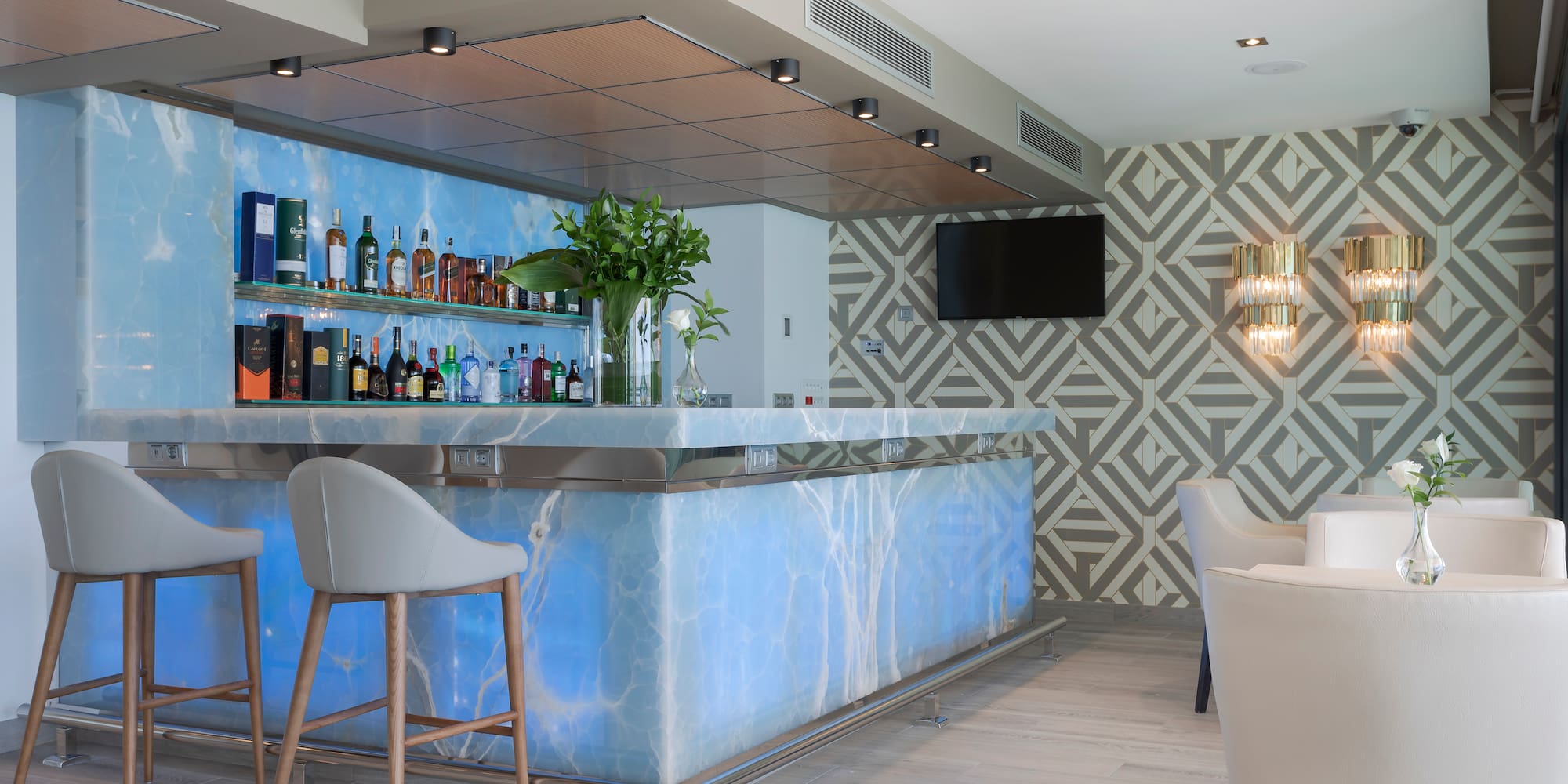 a bar with a blue counter and chairs