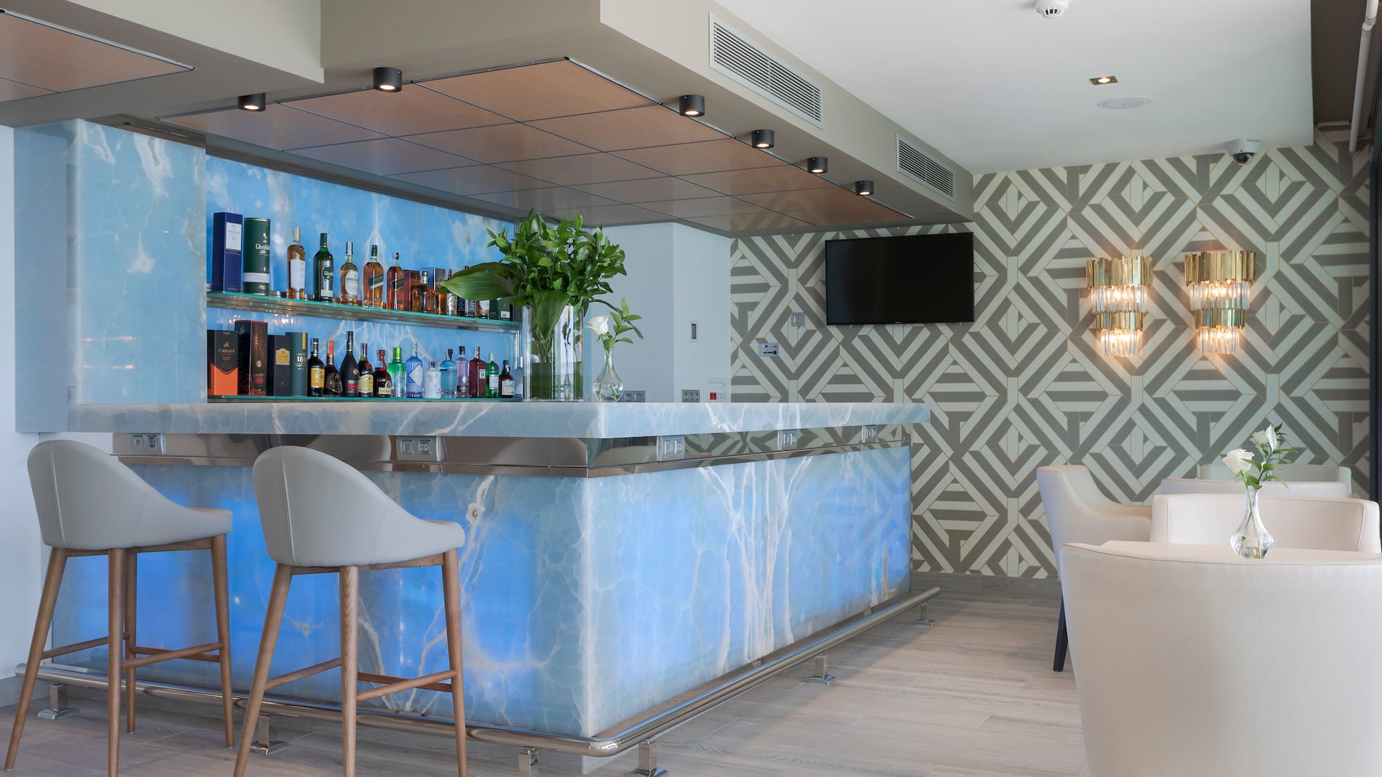 a bar with a blue counter and chairs