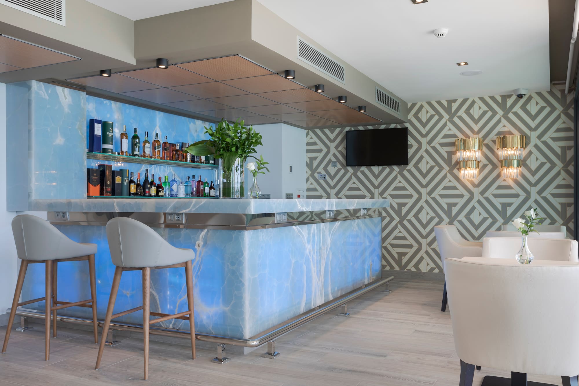 a bar with a blue counter and chairs