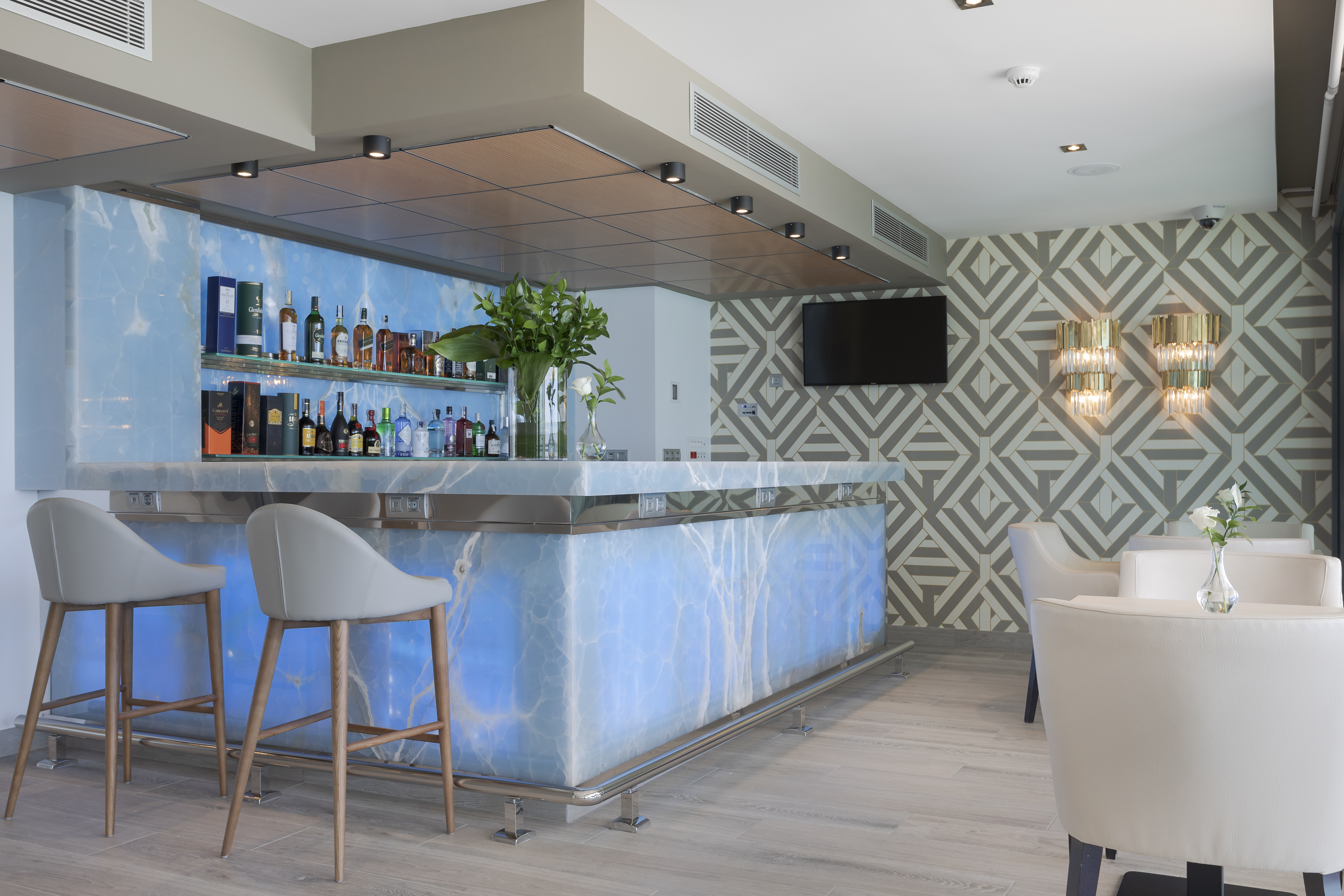 a bar with a blue counter and chairs