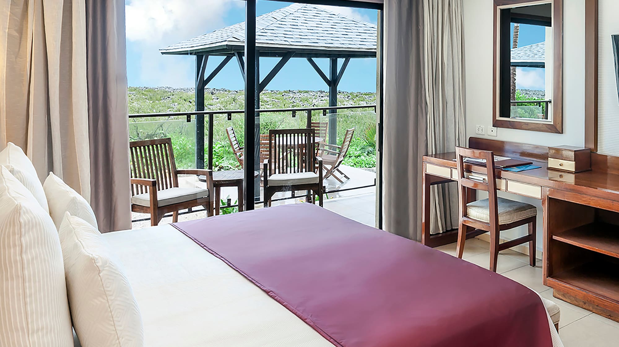 a bedroom with a large window and a table
