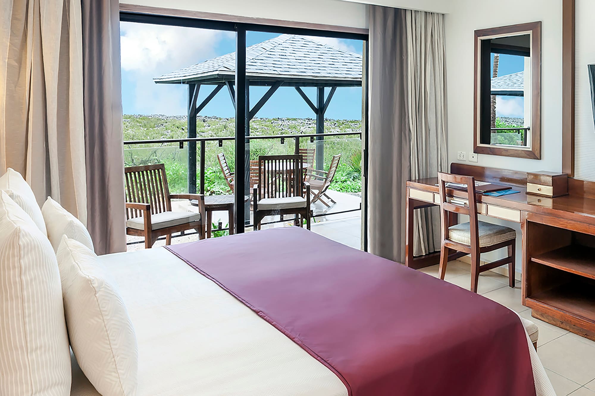 a bedroom with a large window and a table