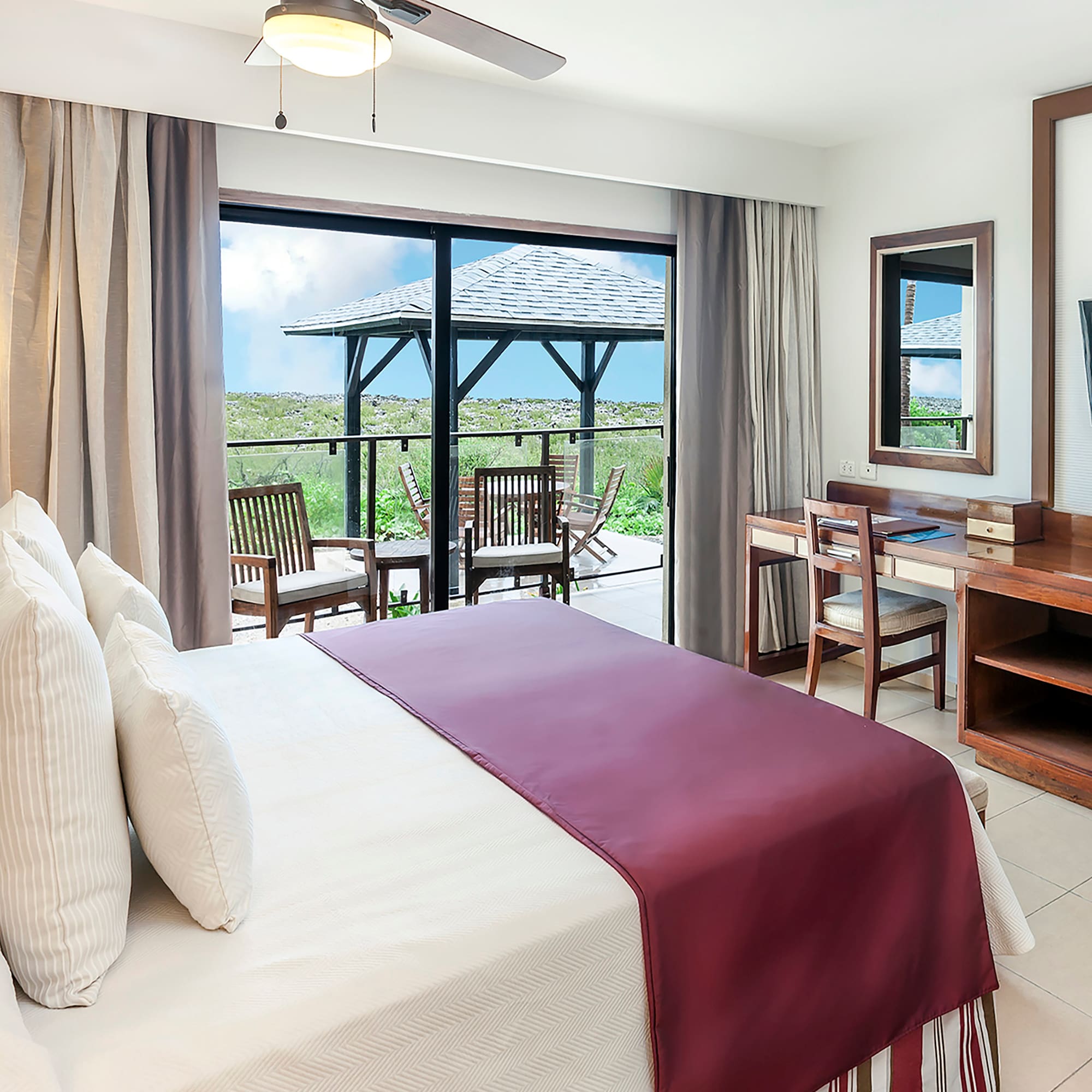 a bedroom with a large window and a table