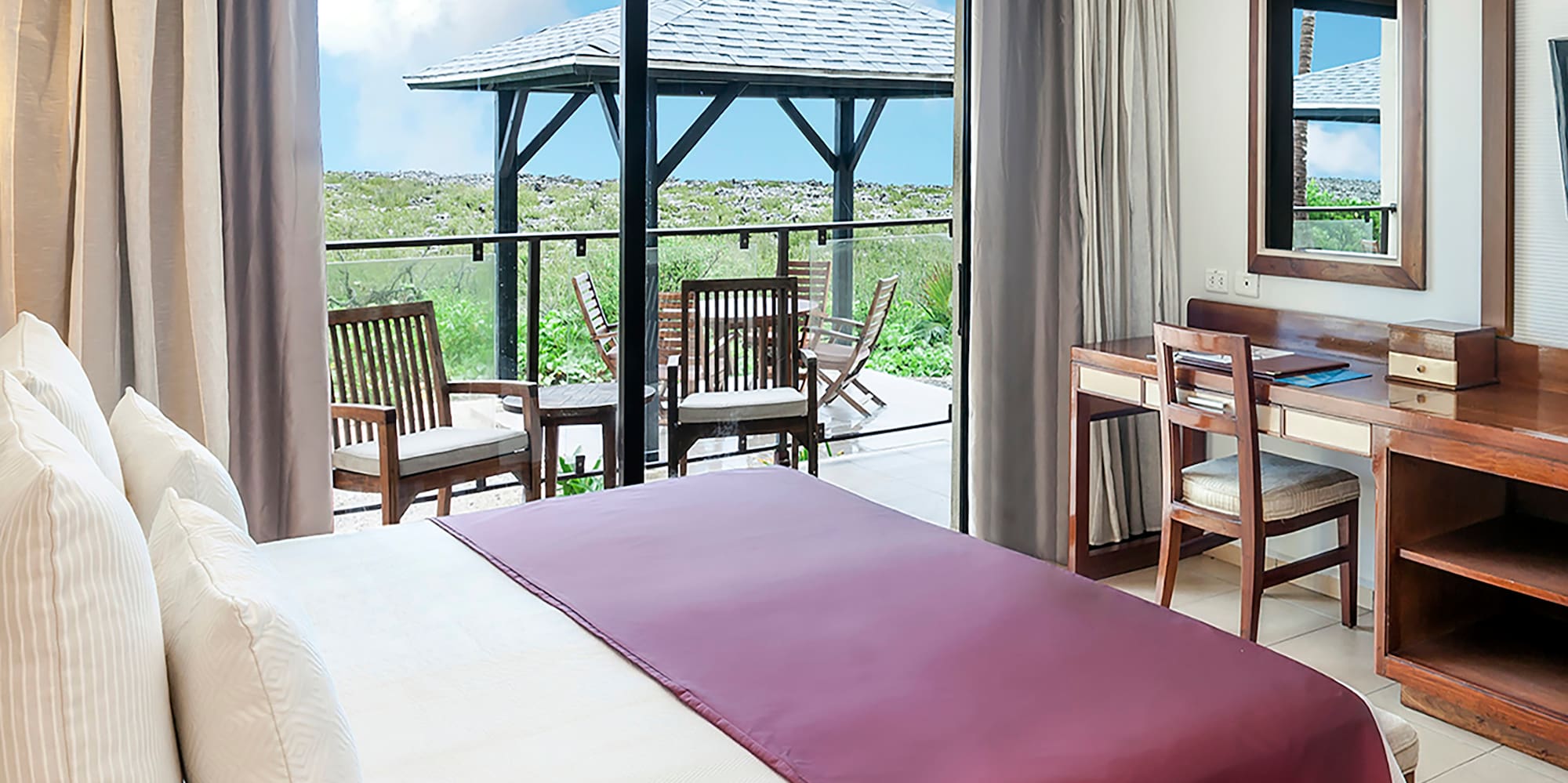 a bedroom with a large window and a table