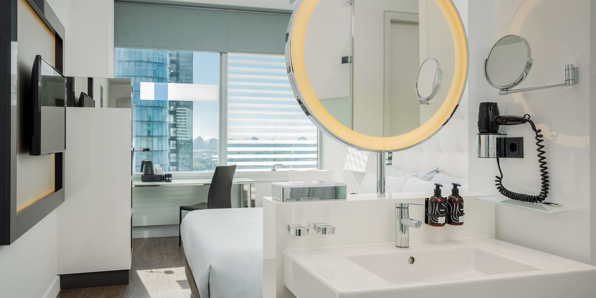 a bathroom with a mirror and a bed