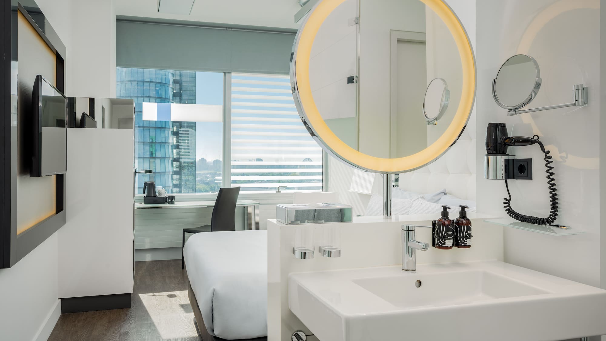 a bathroom with a mirror and a bed