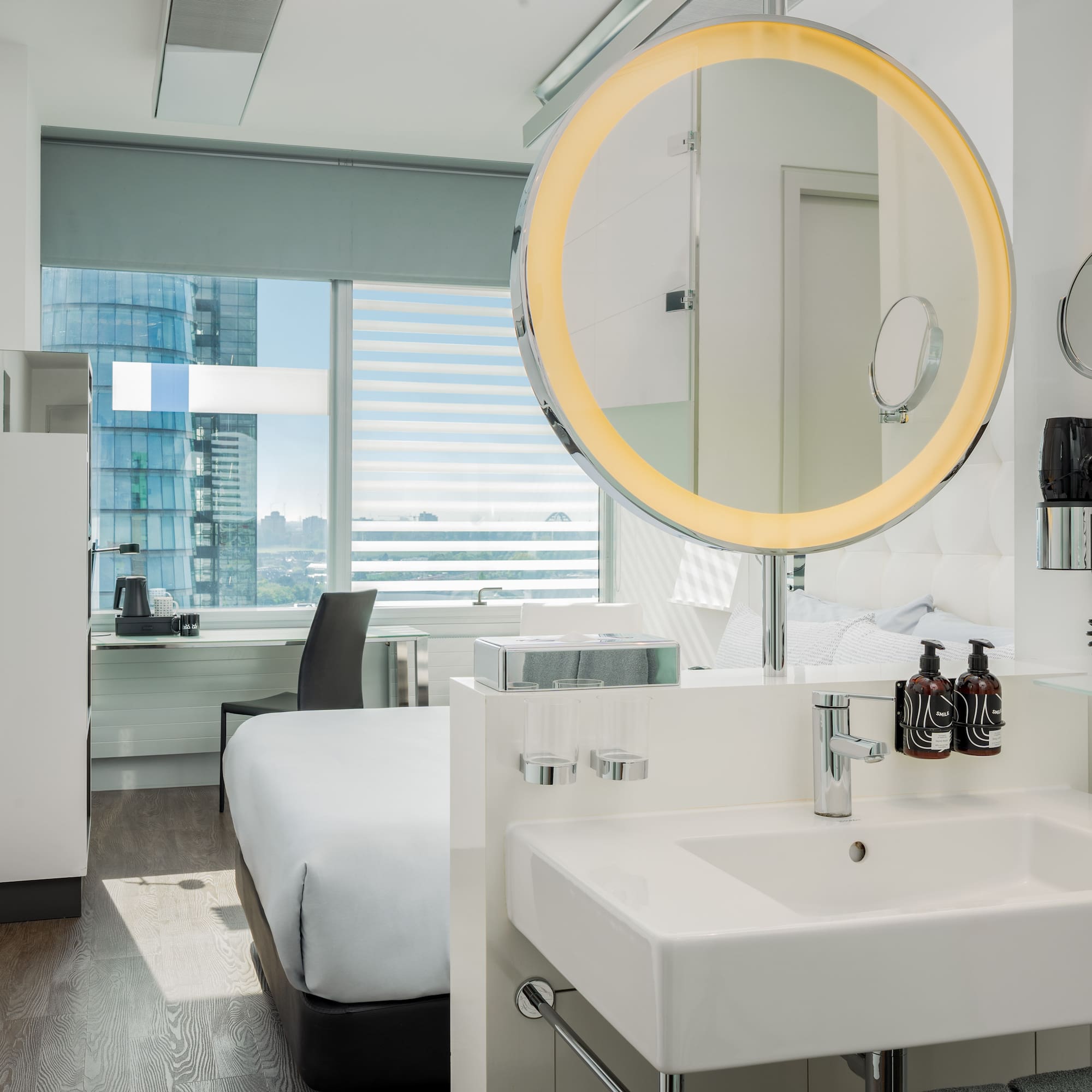 a bathroom with a mirror and a bed