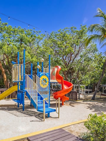 a playground with a slide and a slide