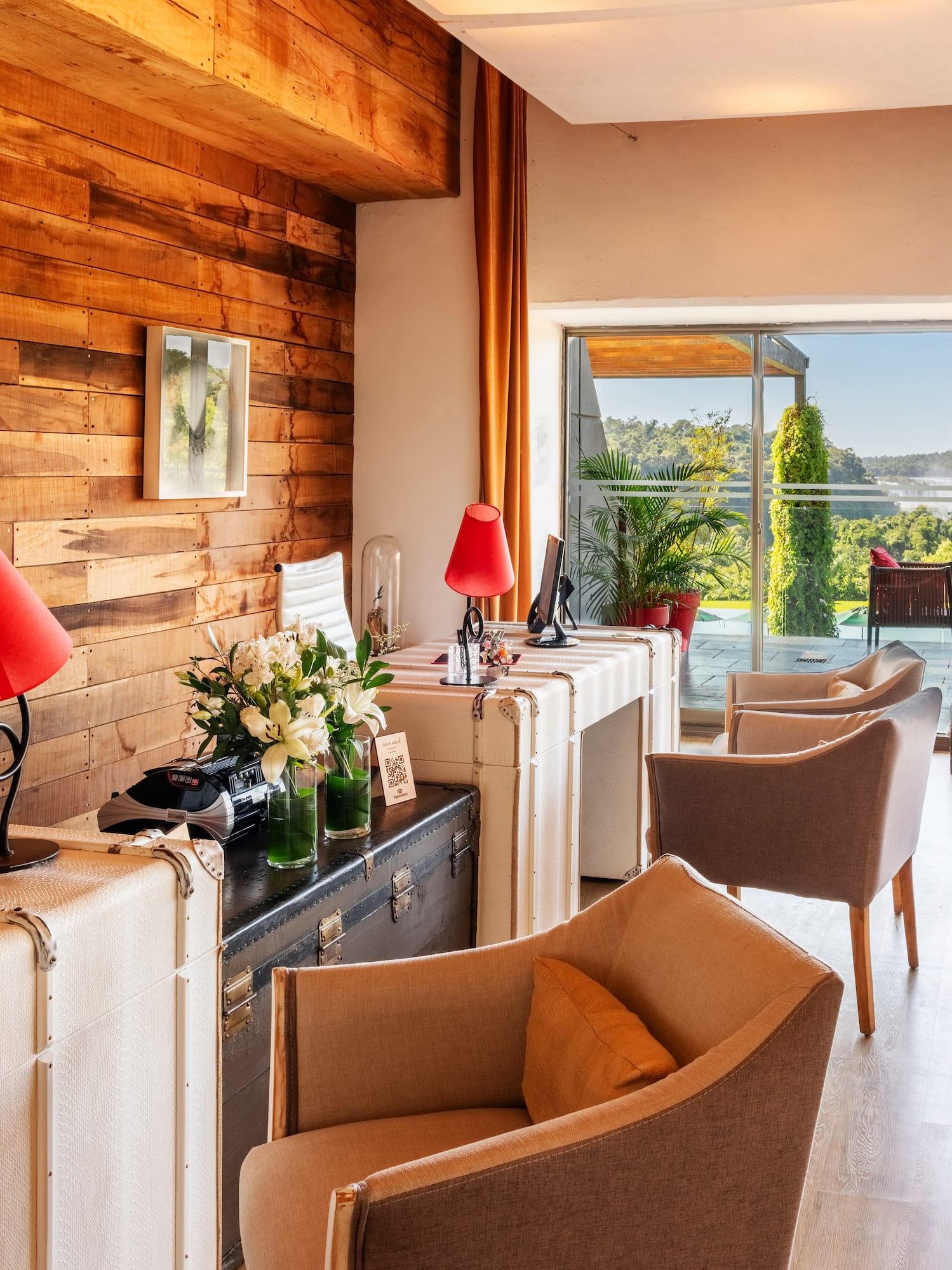 a room with a computer and a desk and chairs