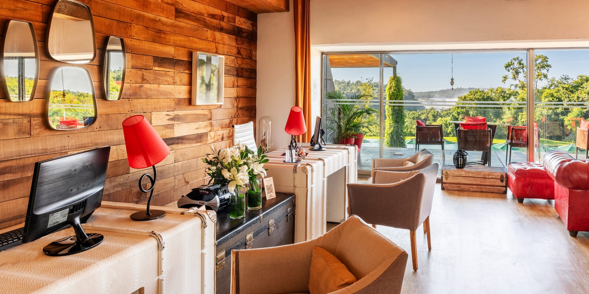 a room with a computer and a desk and chairs