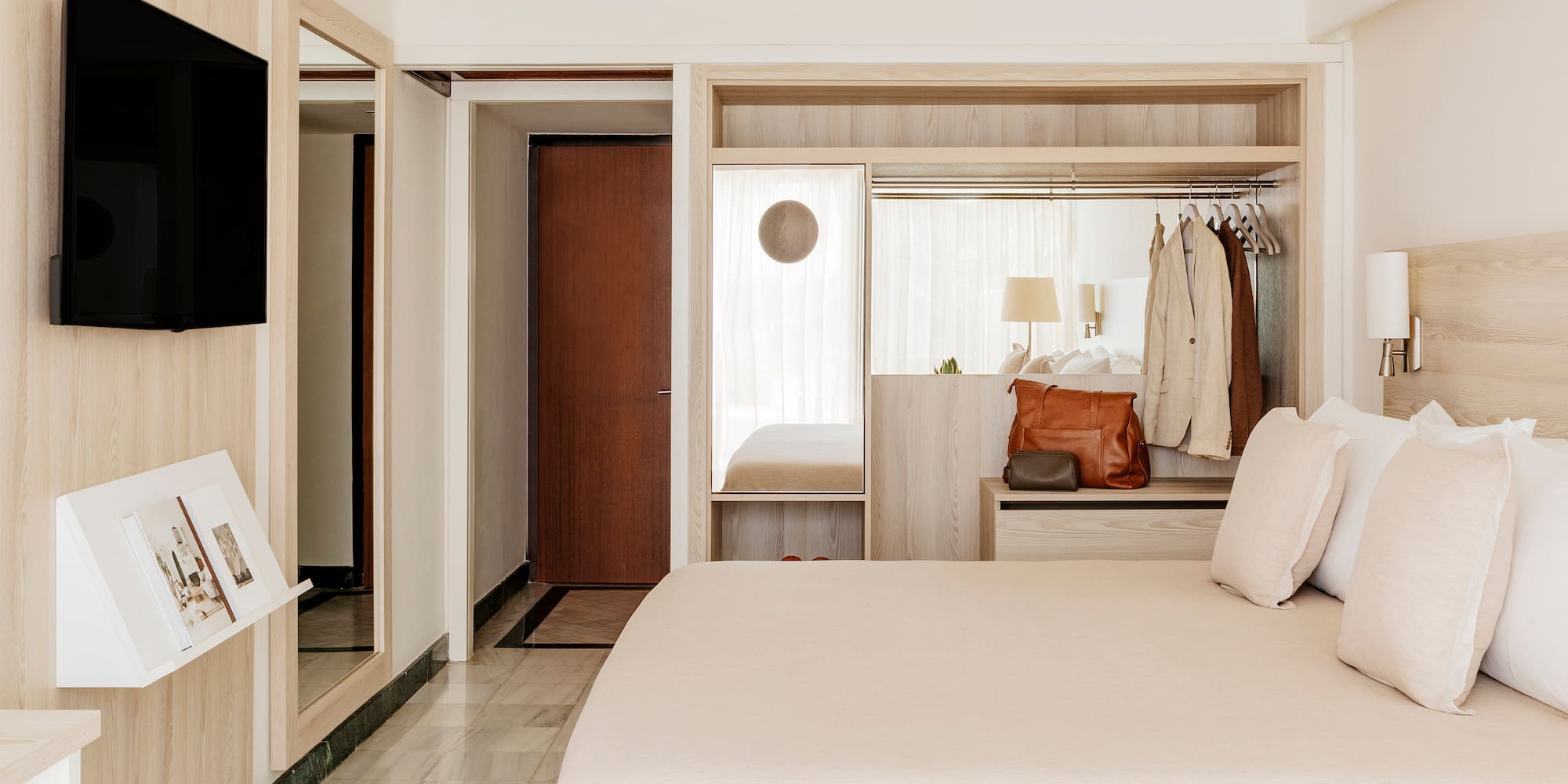 a bedroom with a bed and a mirror