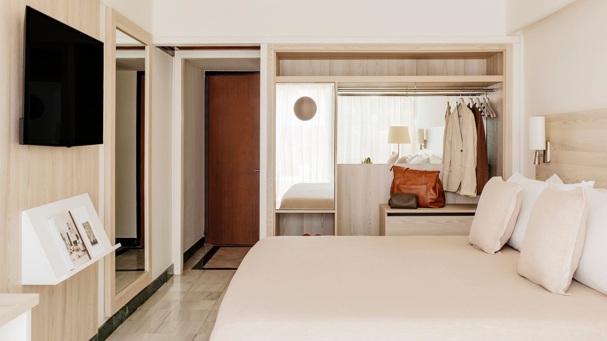 a bedroom with a bed and a mirror