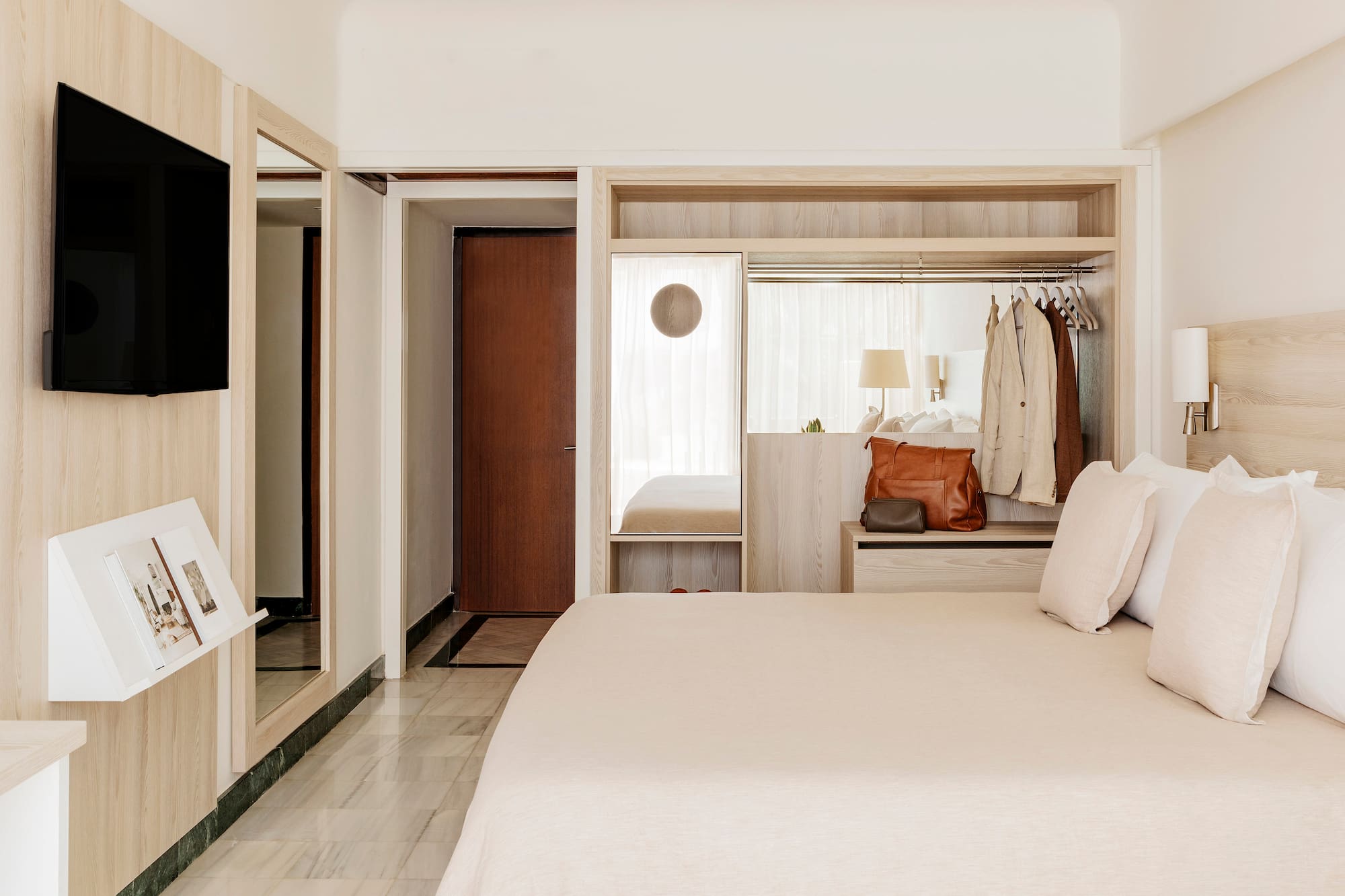 a bedroom with a bed and a mirror