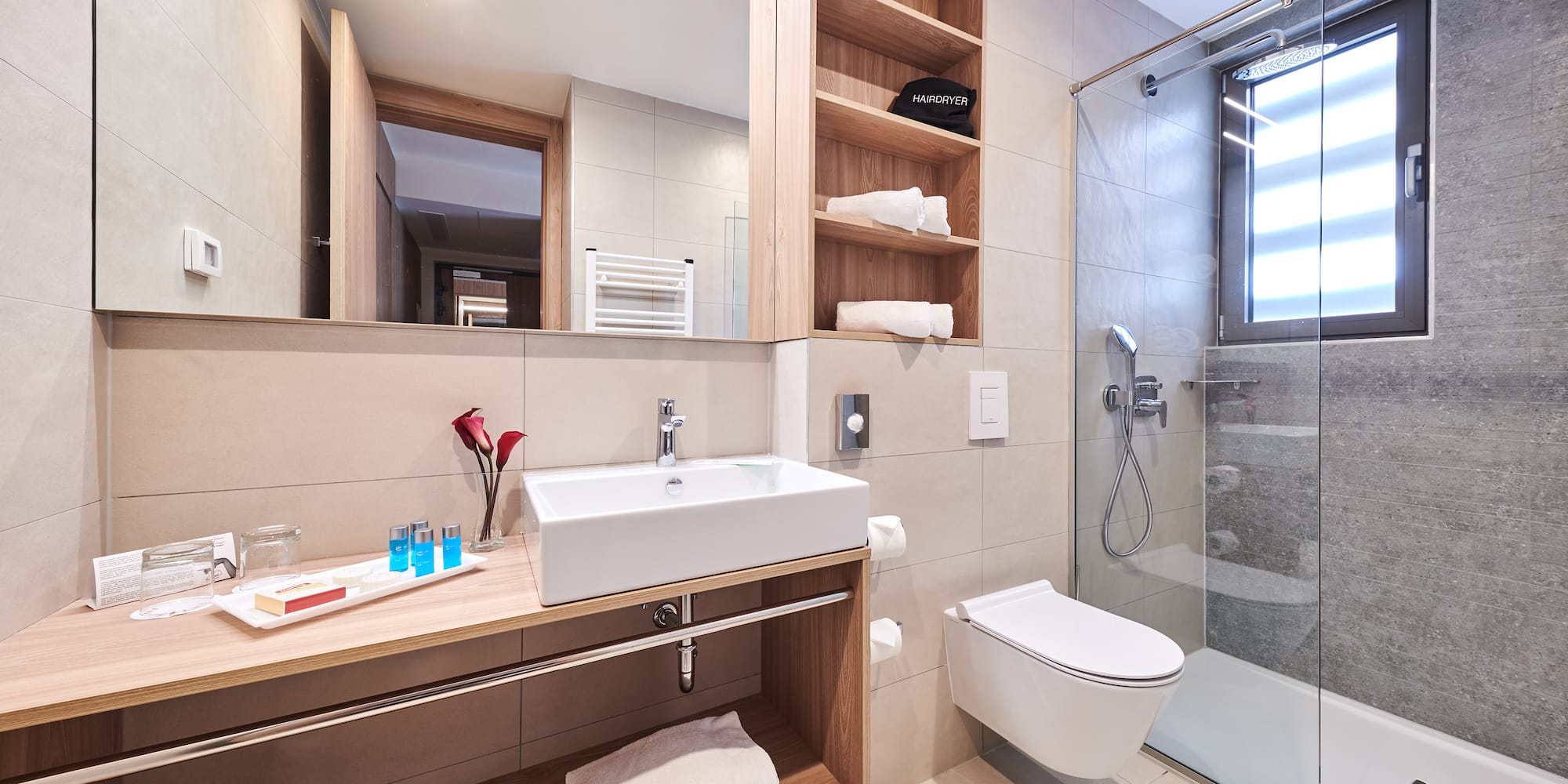 a bathroom with a glass shower and sink