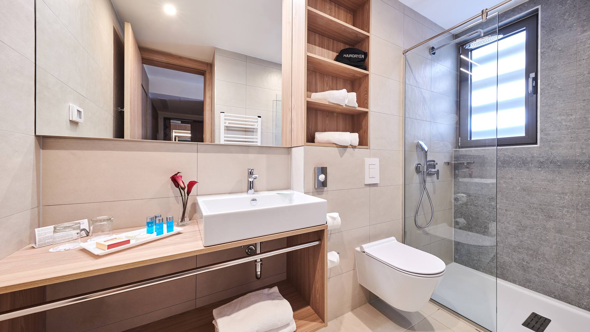 a bathroom with a glass shower and sink