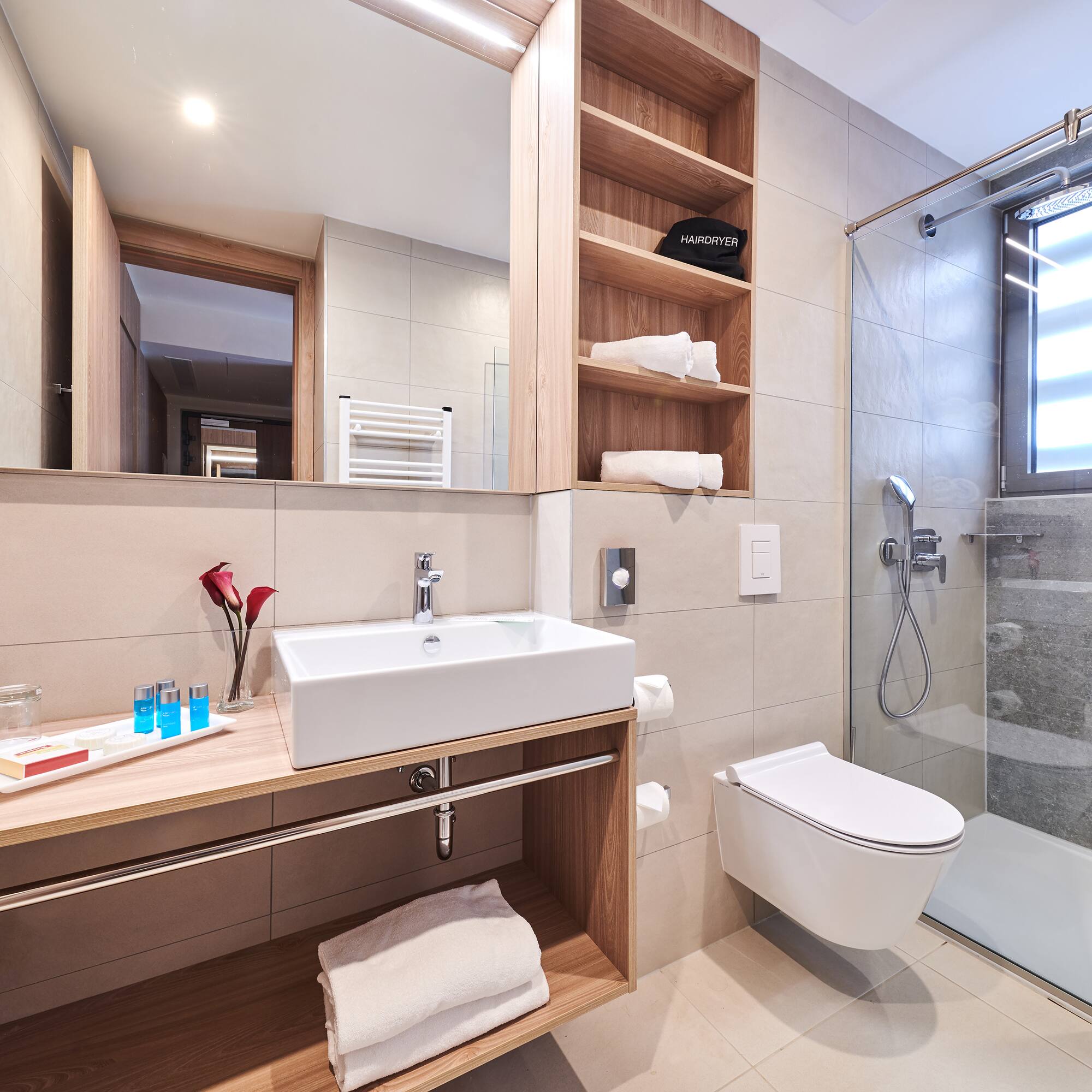 a bathroom with a glass shower and sink
