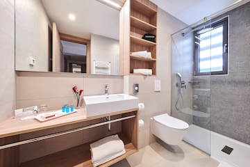 a bathroom with a glass shower and sink
