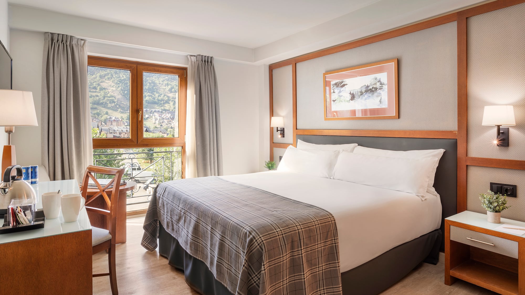 a bed with a chair and a table in a room with windows