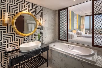 a bathroom with a mirror and a tub
