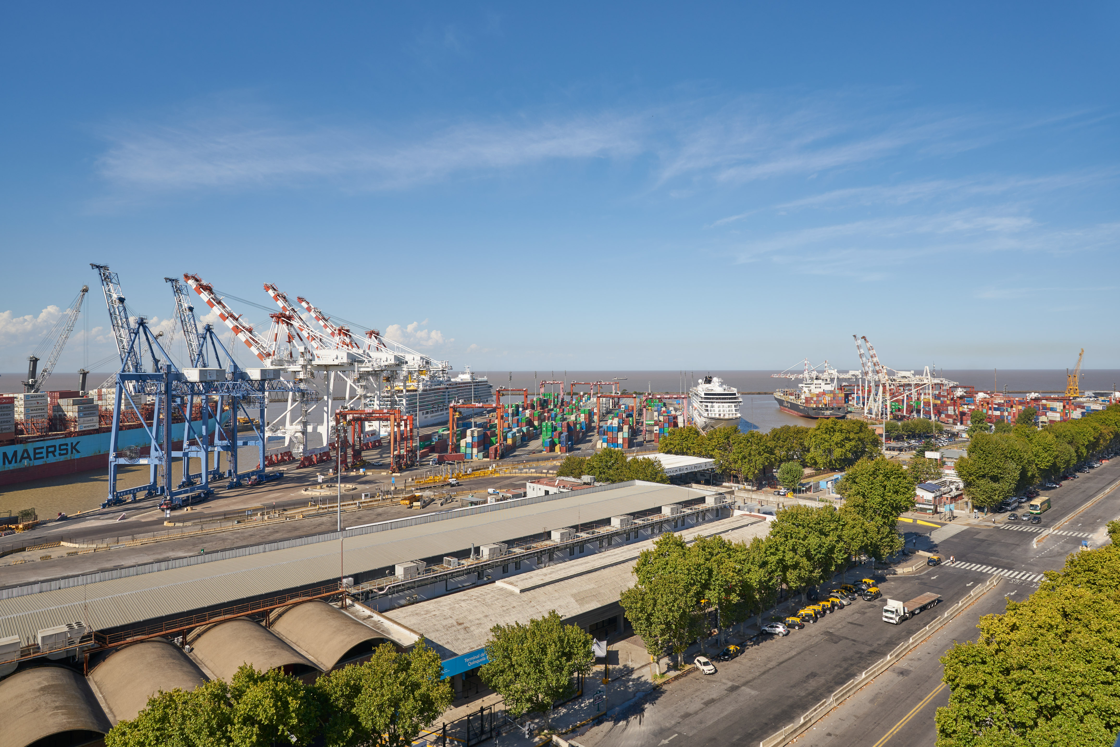 Buenos Aires port with cargo ships, cruise ships, cranes, and containers.
