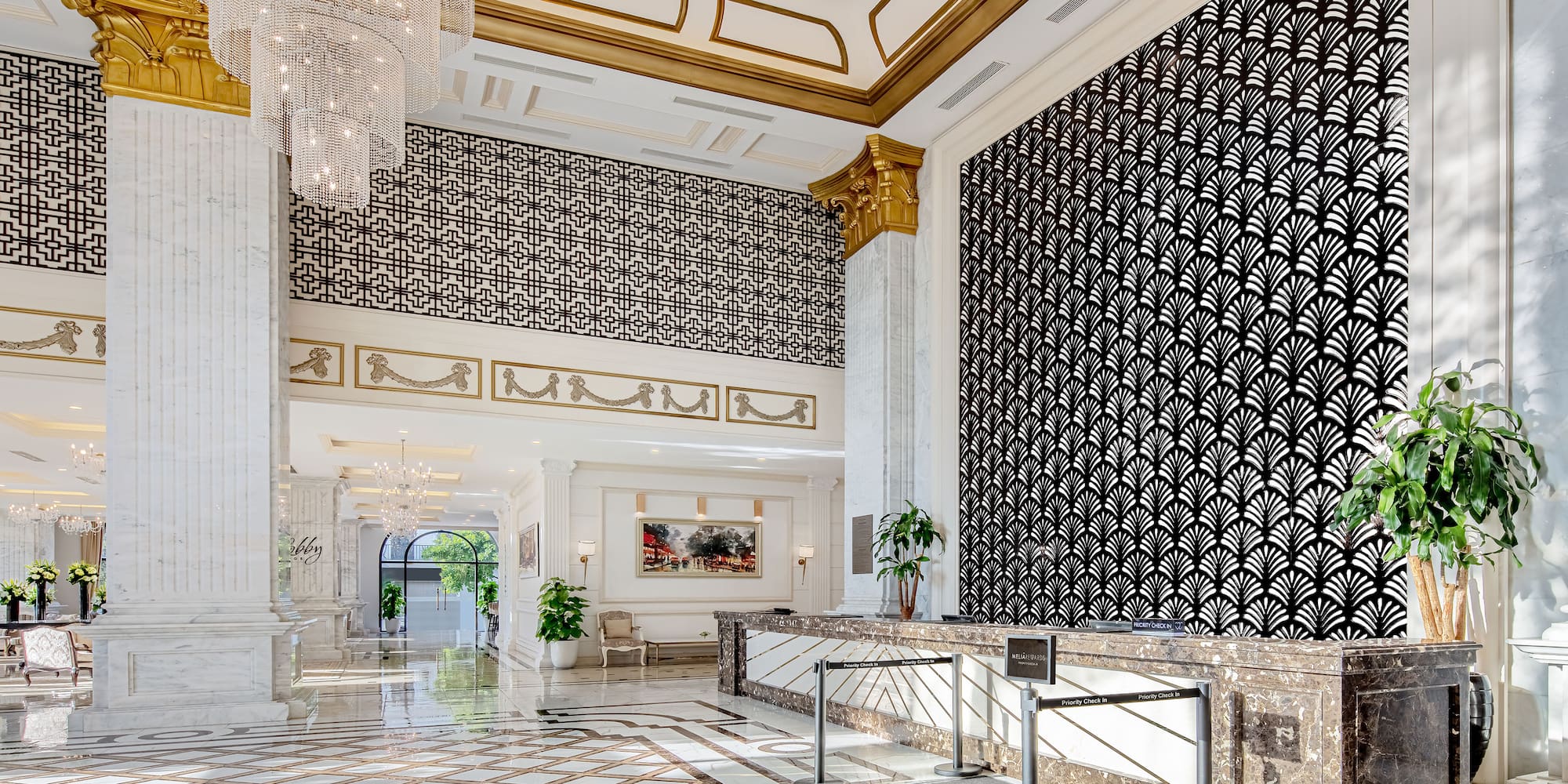 a large lobby with a chandelier and a large wall