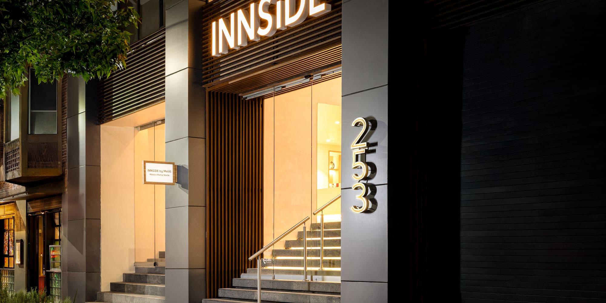 INNSIDE by Meliá hotel entrance, Mexico Roma Norte, glowing sign at night.