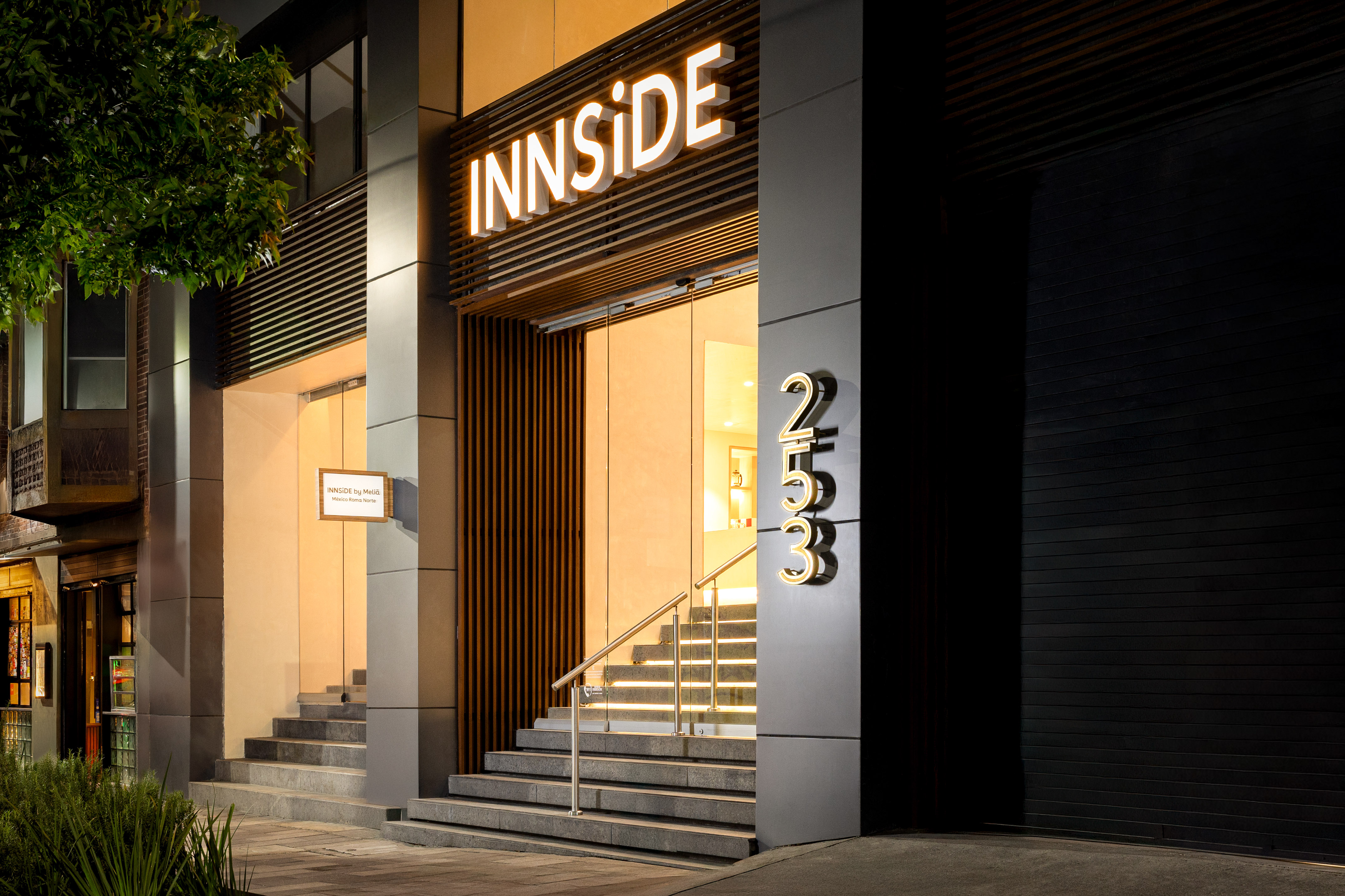 INNSIDE by Meliá hotel entrance, Mexico Roma Norte, glowing sign at night.
