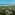 High view of tropical resort villas, palm trees, sandy beach, and blue ocean.