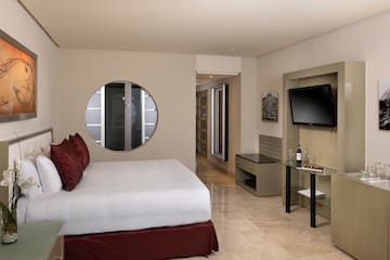 a bedroom with a television and a bed