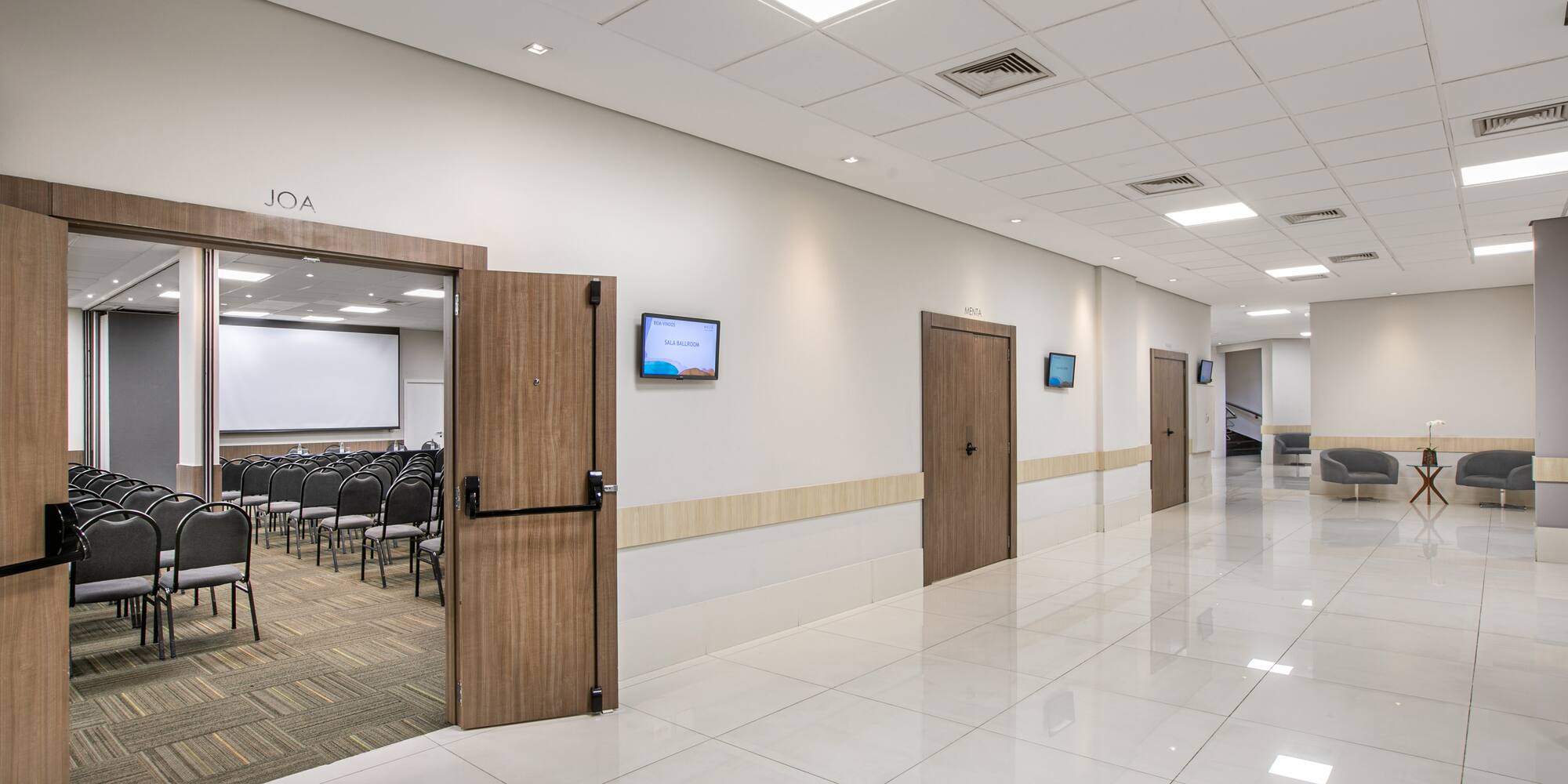 a room with a door open and a room with chairs