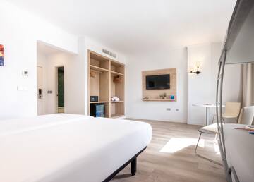 a room with a bed and a tv