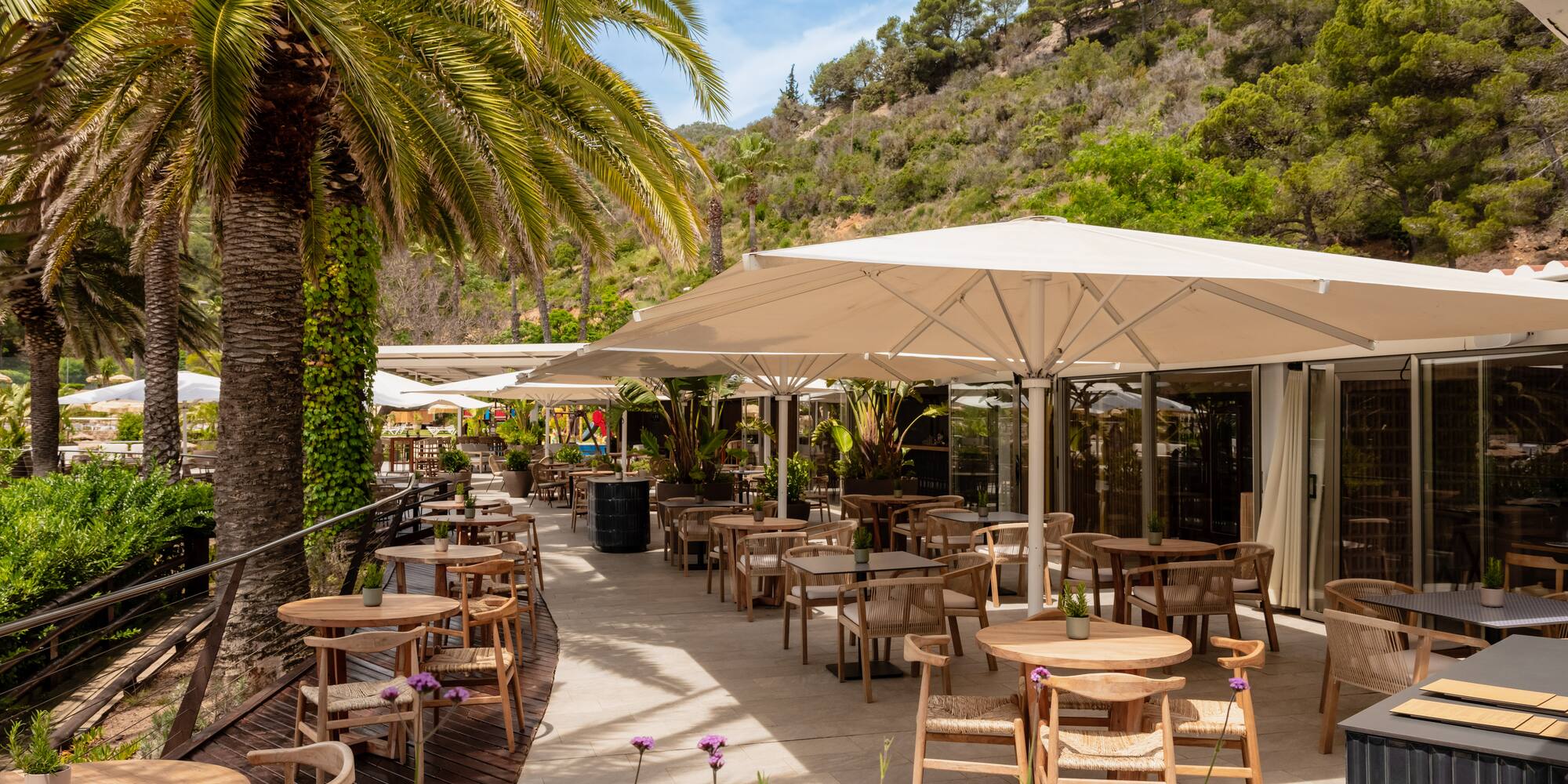 a patio with tables and umbrellas