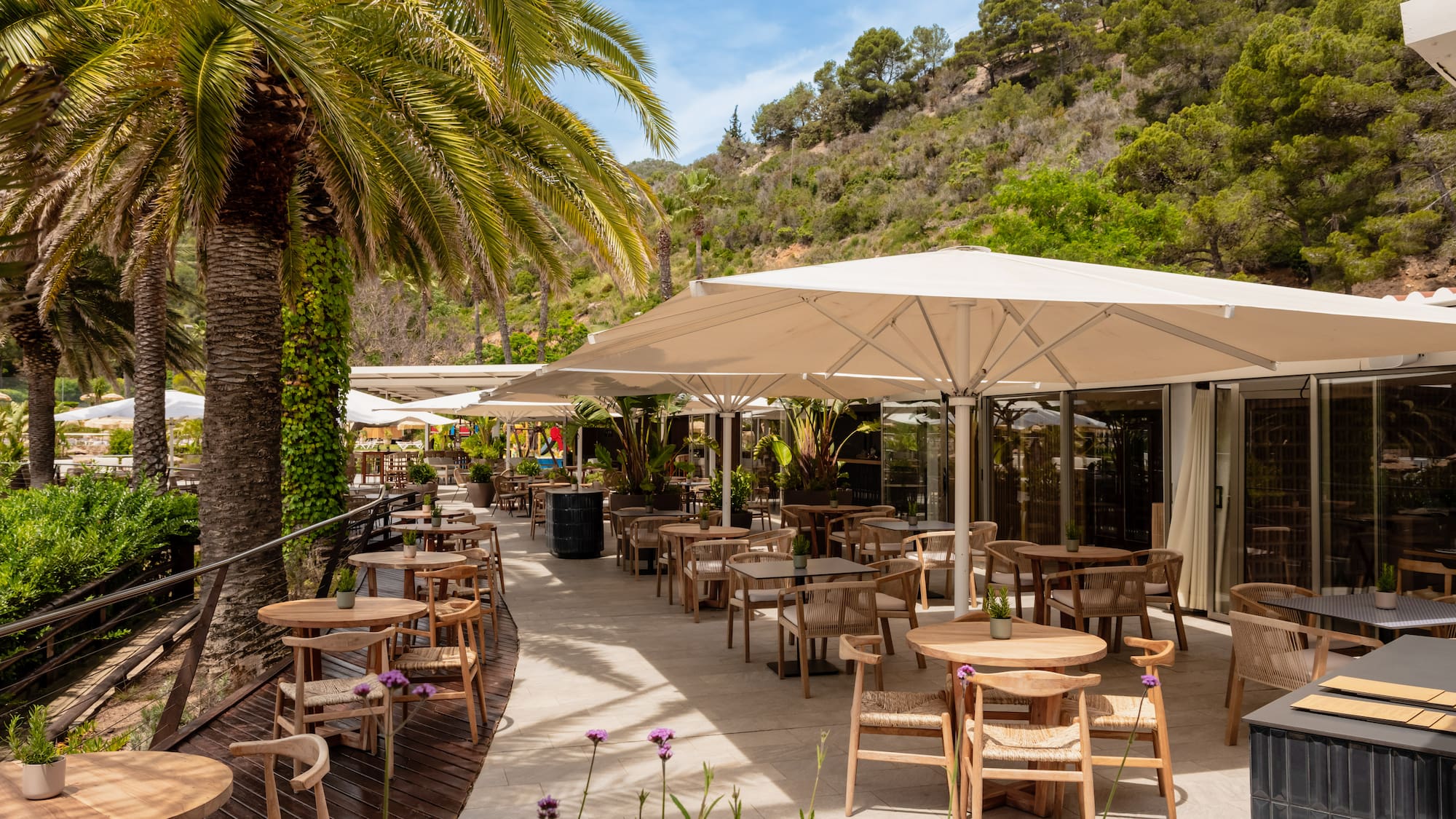 a patio with tables and umbrellas