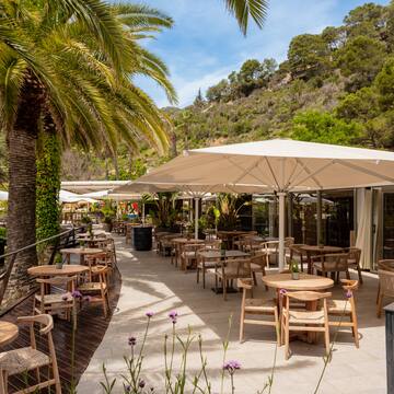 a patio with tables and umbrellas