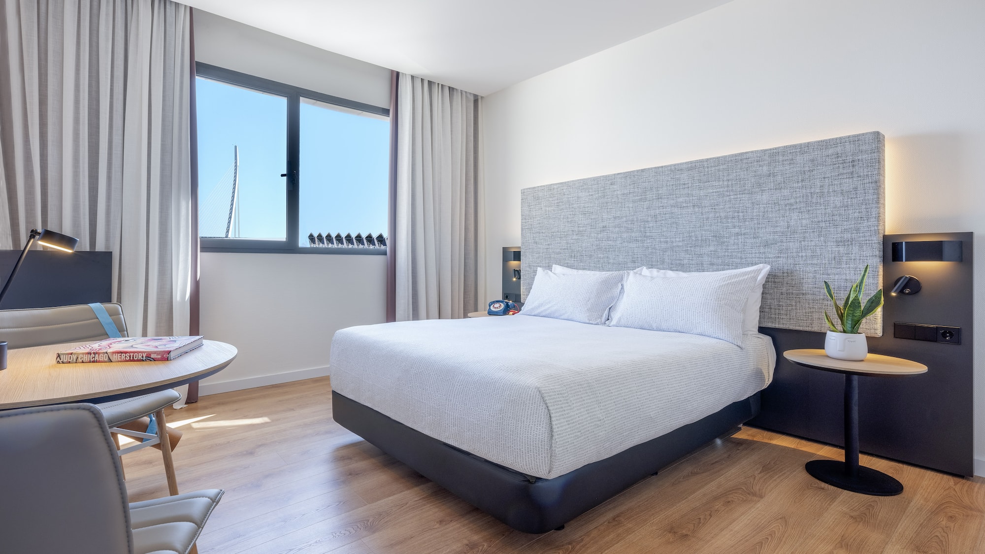 a bedroom with a bed and a table