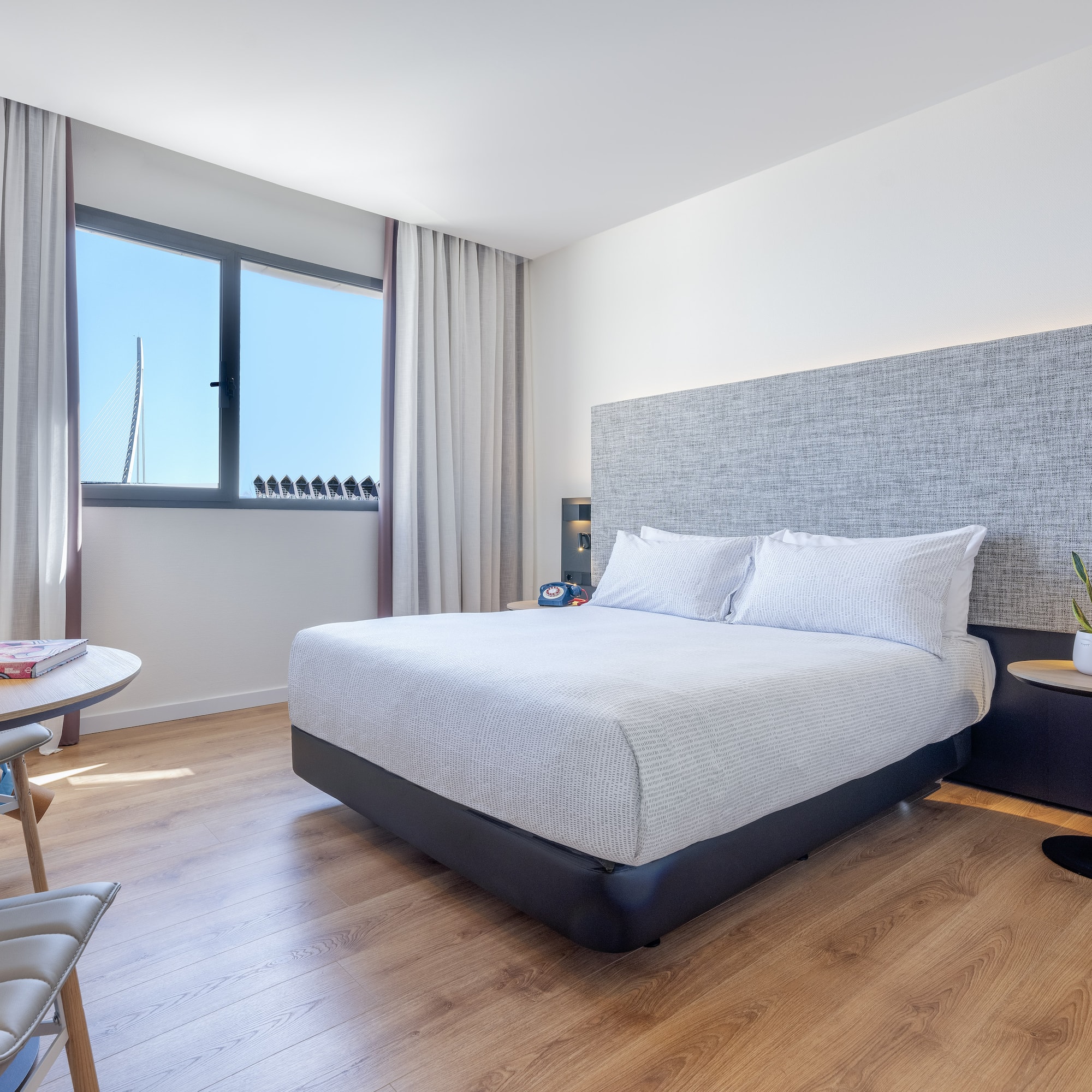 a bedroom with a bed and a table