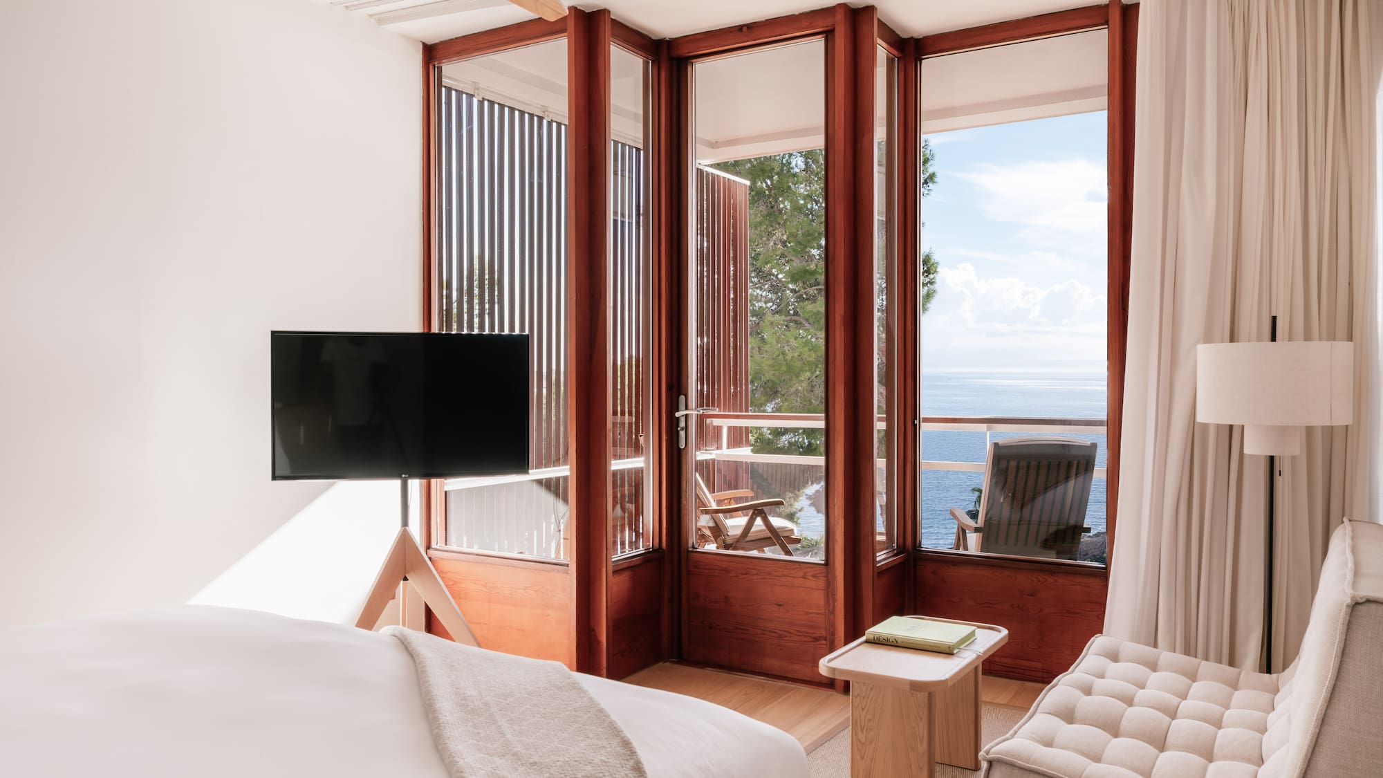 a bedroom with a television and a chair