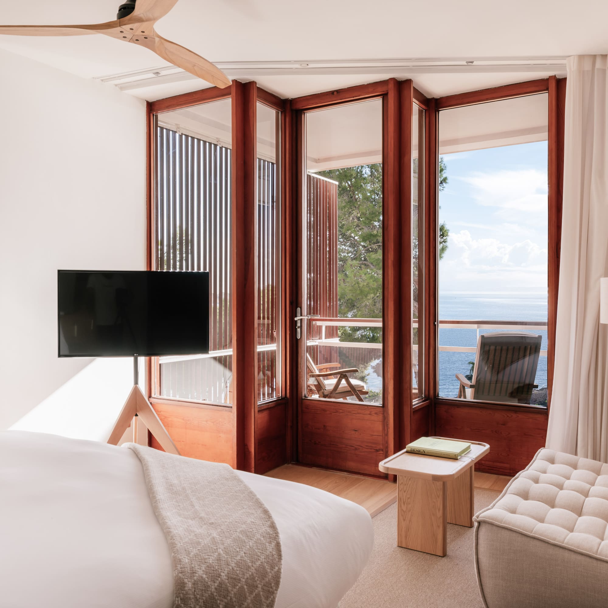 a bedroom with a television and a chair