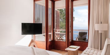 a bedroom with a television and a chair