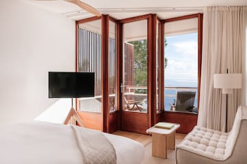 a bedroom with a television and a chair